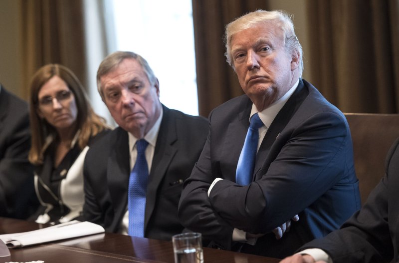 President Donald Trump, Senate Minority Leader Richard Durbin and Rep. Martha McSally, R-Ariz., participate in a bipartisan congressional meeting on immigration in the Cabinet Room at the White House on Tuesday. Photo by Kevin Dietsch/UPI