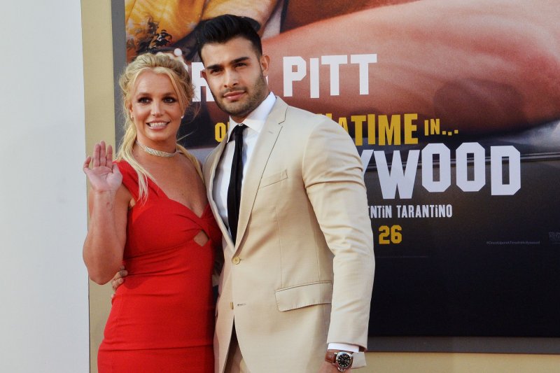 Britney Spears (L), pictured with Sam Asghari, shared a cover and release date for her memoir, "The Woman in Me." File Photo by Jim Ruymen/UPI