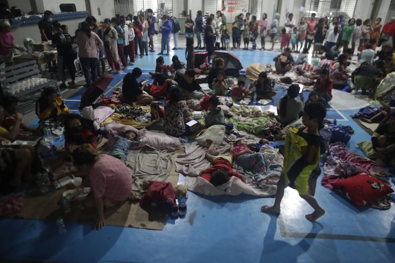 Evacuees rest inside a gymnasium turned into a temporary evacuation center in Manila, Philippines, on Sunday. Photo by Francis R. Malasig/EPA-EFE