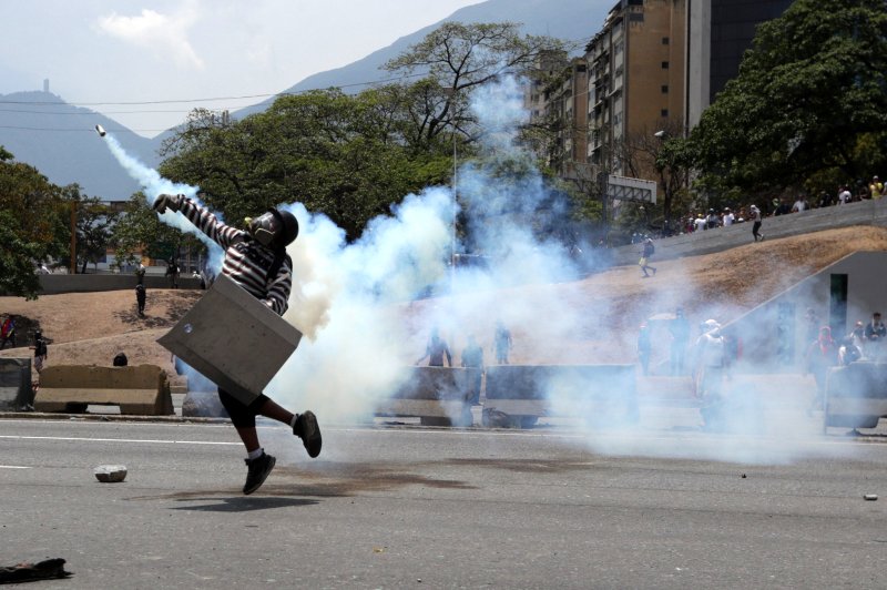 Demonstrators protest in Caracas, Venezuela, on Wednesday, after National Assembly leader Juan Guaido called for action against President Nicolas Maduro. Photo by Rayner Pena/EPA-EFE