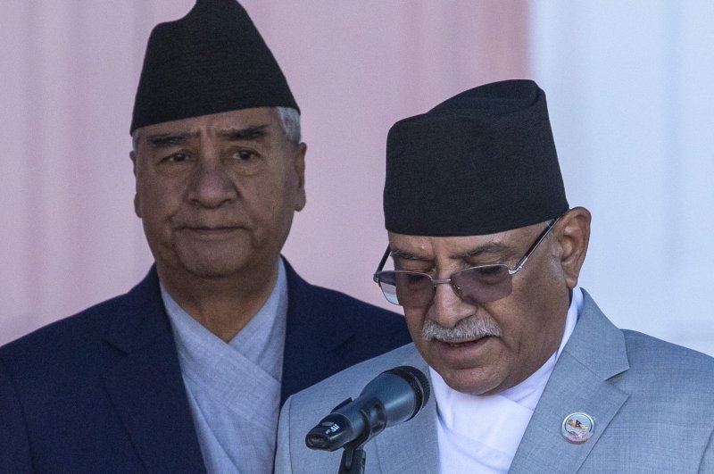 Pushpa Kamal Daha (R), known as Prachanda, takes the oath of office as Prime Minister of Nepal in Kathmandu on Monday while outgoing Prime Minister Sher Bahadur Deuba (L) looks on. Photo by Narendra Shrestha/EPA-EFE