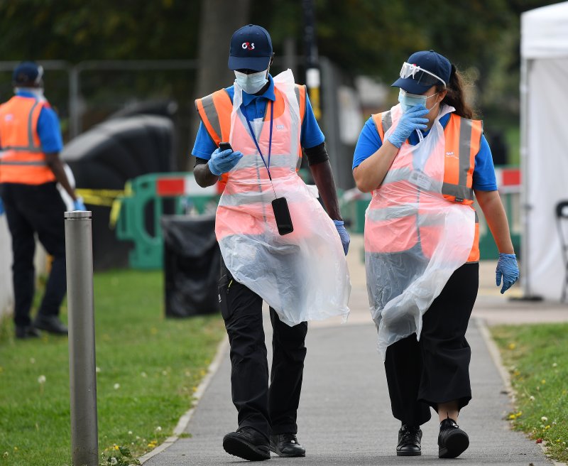 National Health Services&nbsp;staff walk at a self administered Covid-19 testing site in London on September 16, 2020. File Photo by Andy Rain/EPA-EFE