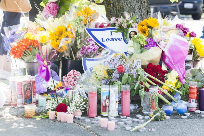 On Sunday, a memorial appears for victims near the scene of a shooting Saturday at a Tops Friendly Market grocery store in Buffalo, N.Y.. Photo by Brandon Watson/EPA-EFEWATSON