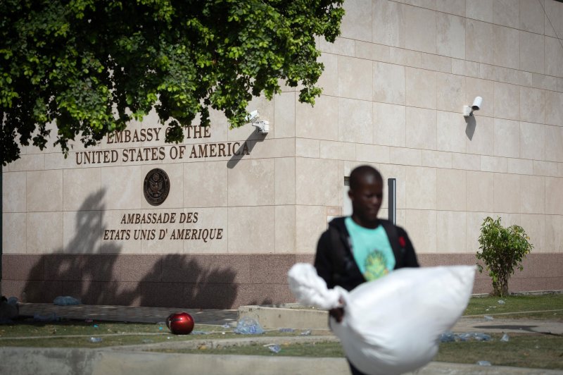 A person walks in front of the United States embassy in Port-au-Prince, Haiti, on July 25. The embassy closed because of gunfire on Tuesday. Photo by Johnson Sabin/EPA-EFE