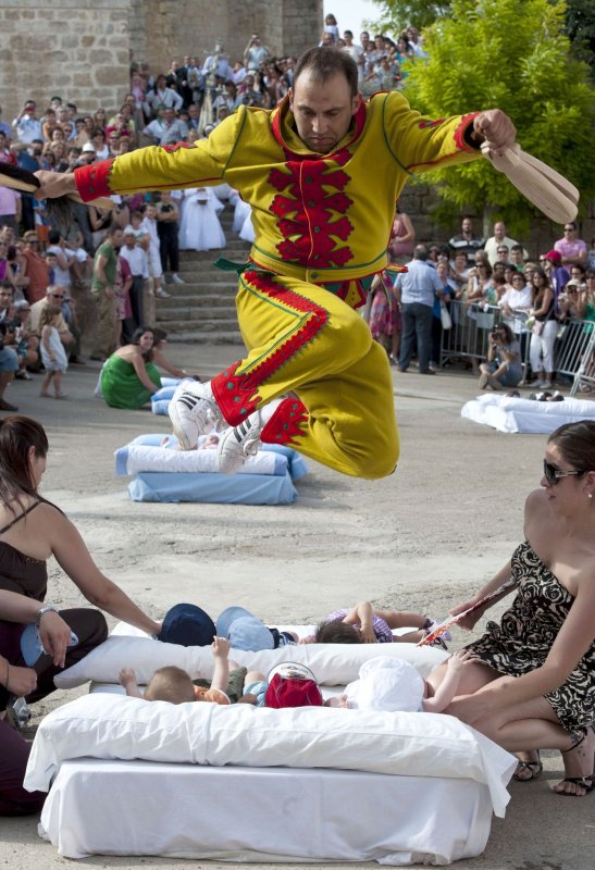 Devils jump over babies in Spanish village's unusual festival