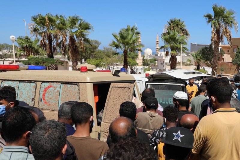 People wait as the remains of flood victims, who washed ashore from the sea, are brought to the hospital of Derna, Libya. Photo by Mohamed Shalash/EPA-EFE