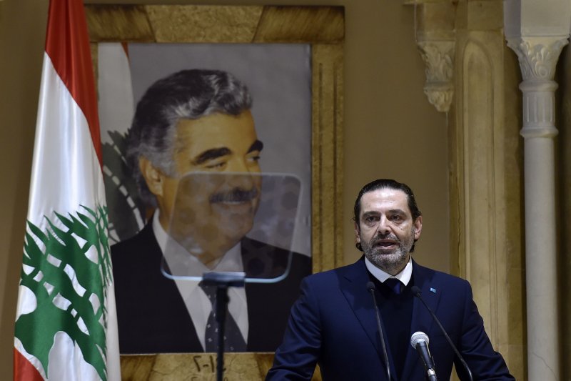 Former Lebanese Prime Minister Saad Hariri, standing in front of a portrait of his late father former premier Rafik Hariri, speaks during a news conference at his house in downtown Beirut, Lebanon, on Monday. Hariri announced his withdrawal from political life and he would not run in the parliamentary elections 2022. Photo by Wael Hamzeh/EPA-EFE