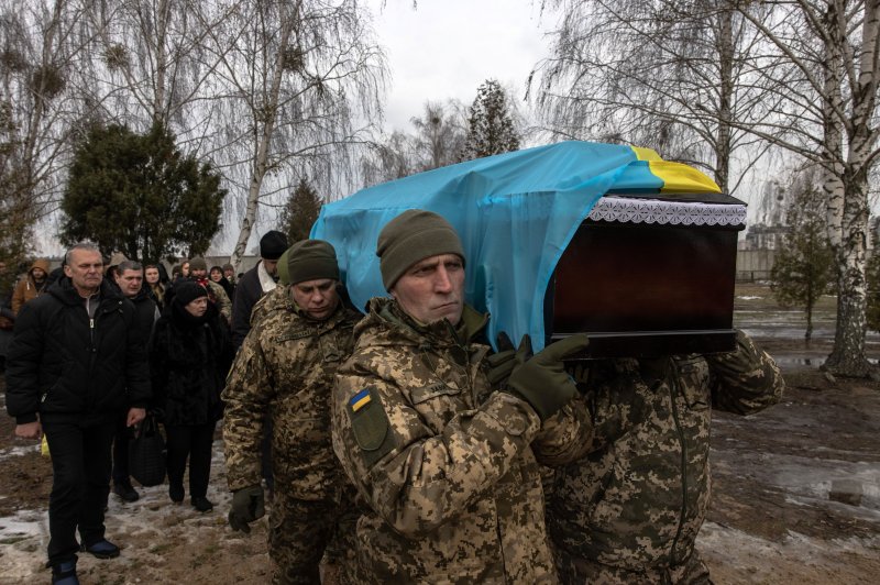Ukrainian servicemen carry the coffin of a Ukrainian soldier during a funeral ceremony at a cemetery in Bucha, northwest of Kyiv, Ukraine, on Friday. Photo by Roman Pilipey/EPA-EFE