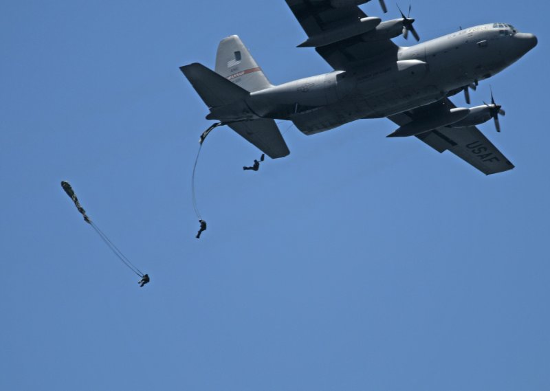 U.S. Navy SEALs jump out of an airplane with the aid of parachutes as part of a training exercise. Chief Special Warfare Operator Bradley S. Cavner died Wednesday when his parachute failed deploy during one such exercise. File photo courtesy the U.S. Navy