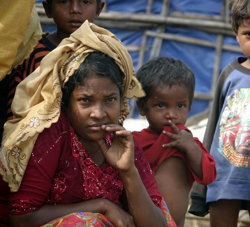 Rohingya people are seen near a makeshift house in Maungdaw, Rakhine State in western Myanmar. According to the United Nations, hundreds of thousands of Rohingya refugees have fled Myanmar since the army launched a military offensive in August 2017. File Photo by Nyunt Win/EPA-EFE