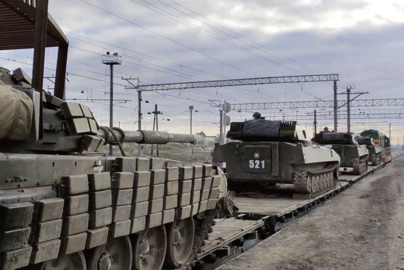 Russian armored fighting vehicles load onto railway freight carriages in Bakhchysarai, Crimea, on Tuesday as part of Moscow ordering some troops involved in military exercises to return to their bases. Photo courtesy of Russian Defense Ministry via EPA-EFE