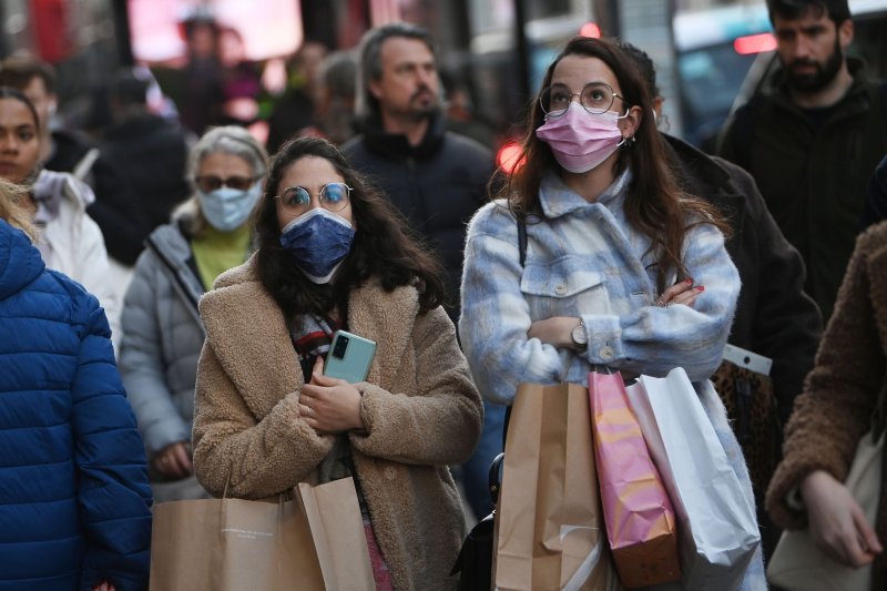 Masked pedestrians are seen walking in London, Britain, on December 9, 2021. "Plan B" COVID-19 restrictions will soon be lifted in Britain because Omicron-driven cases have peaked, Prime Minister Boris Johnson said Wednesday. File Photo by Neil Hall/EPA-EFE