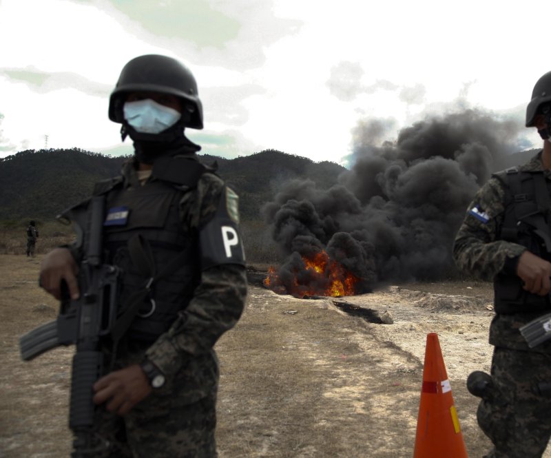 Members of the Honduras' National Inter-Institutional Security Force (Fusina) participate in the destruction of 1,572 pounds of cocaine at a military installation in the village Las Casitas, south of Tegucigalpa on January 11. Honduras, which faces violence due to drug gangs, has one of the highest homicide rates in the word. On Saturday, the bodies of three teenagers out of four who were kidnapped in Honduras have been found hand-tied inside of plastics blags by a river. Photo by Gustavo Amador/EPA