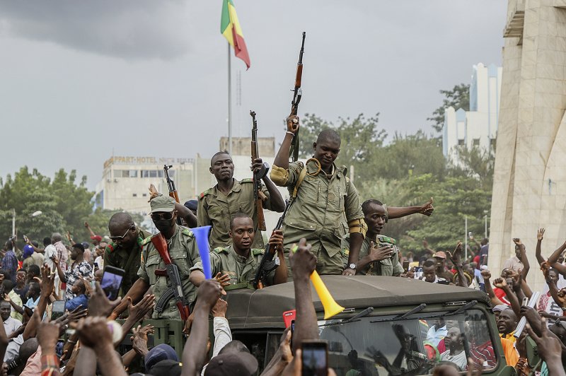 Malians cheer as Mali military personnel enter the streets of Bamako, Mali, on Aug. 18, 2020. Sixteen countries, including France, Canada and Britain, signed a statement Thursday condemning the deployment of the Wagner group, a Russian paramilitary organization, in the west African country. File Photo by Moussa Kalapo/EPA-EFE