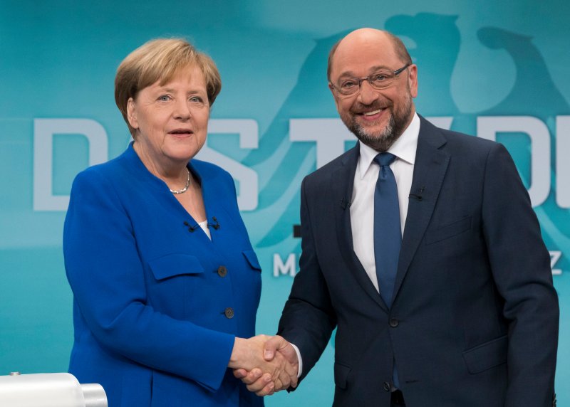 The Social Democartic Party, led Martin Schulz (R), voted in favor of entering a second stage of talks to form a coalition with German Chancellor Angela Merkel (L) and her Christian Democratic Union. File Photo by Herby Sachs WDR/EPA