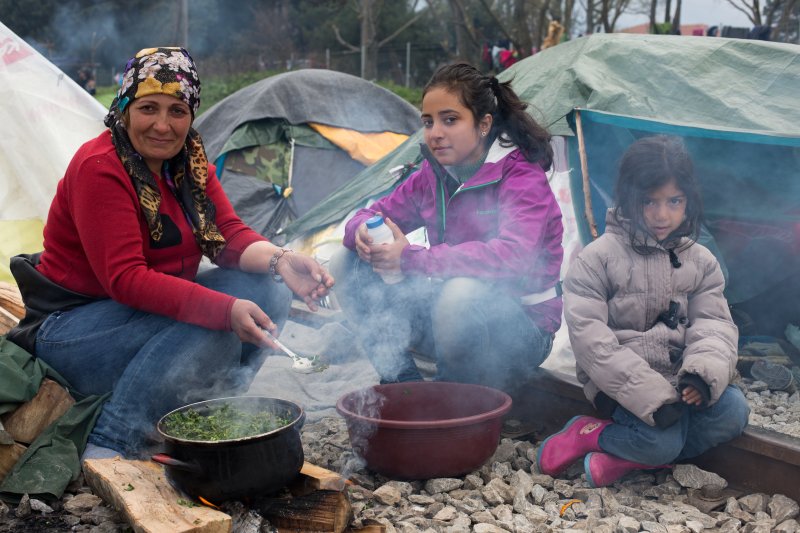 Many families are among the 12,000 refugees stranded in a makeshift camp in Idomeni, Greece, along the border with Macedonia in April 2016 after the border closed. Here a family from Iraq cooks. Many of the migrants are trying to reunite with relatives, who have made it to other parts of Europe. Photo by David Caprara/UPI