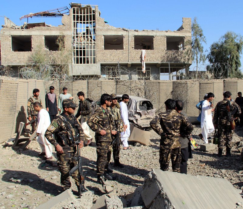 Afghan security officials inspect the scene of a suicide bomb attack that targeted the office of National Directorate of Security in Lashkarga, Helmand, Afghanistan,on Saturday, A suicide bomber was shot dead by the Afghan security forces as he tried to enter the NDS office. Photo by Watan Yar/EPA