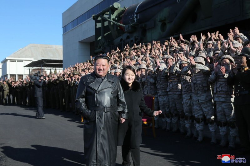An undated photo released by the official North Korean Central News Agency on Sunday shows North Korean leader Kim Jong-un walking with his daughter, presumed to be his second child, Ju-ae, during a photo session with the contributors to the successful test-fire of new-type ICBM Hwasongpho-17 at an undisclosed location in North Korea. Photo by EPA-EFE/KCNA