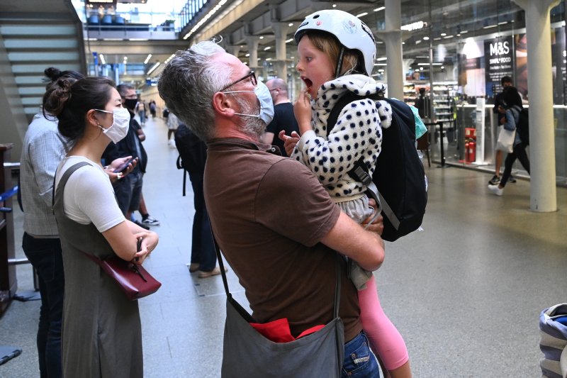 A father greets his daughter at the St. Pancras station in London, Britain, on Friday after she arrived on a Eurostar train from Paris. Early Saturday, travelers arriving from France and several other areas must self-isolate for two weeks. Photo by Facundo Arrizbalaga/EPA-EFE