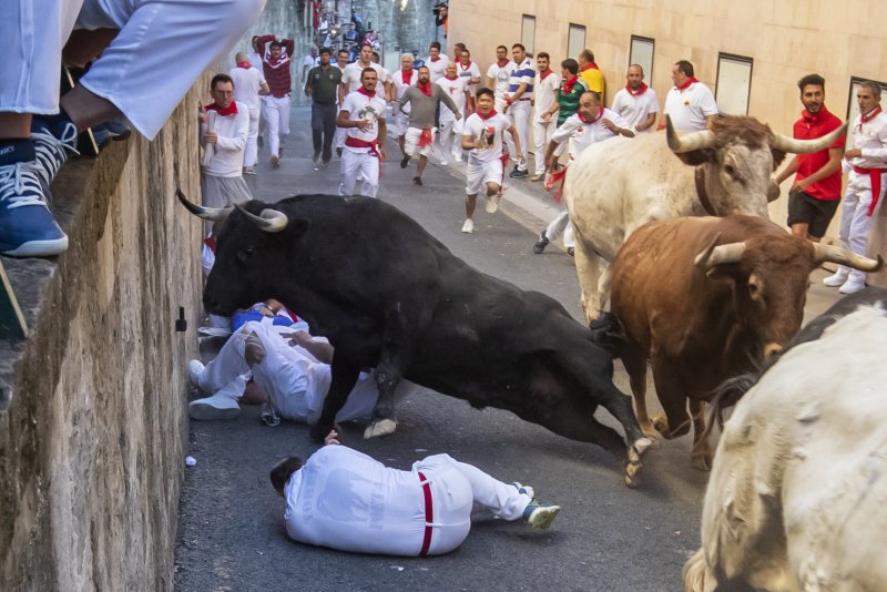 Three people were gored during the final day of the Pamplona bull runs on Sunday, bringing the total for the year to eight. &nbsp;Photo by Jim Hollander/EPA