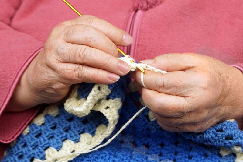 A woman knitting. Photo by Tania Anisimova/Shutterstock.com