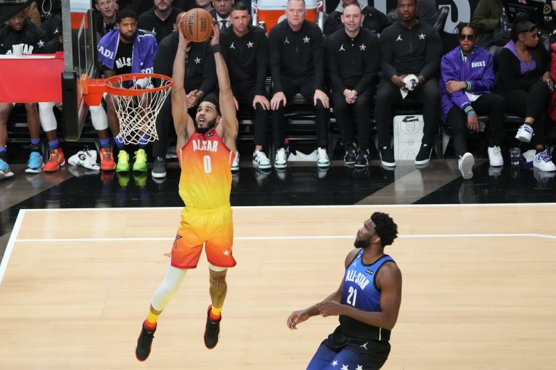 Boston Celtics forward Jayson Tatum of Team Giannis (0) dunks in front of Philadelphia 76ers forward Joel Embiid of Team LeBron at the 72nd NBA All-Star Game on Sunday at Vivint Arena in Salt Lake City. Photo by George Frey/EPA-EFE