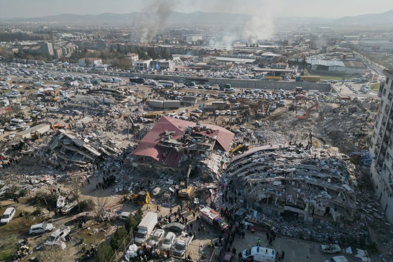 A photo taken with a drone shows emergency services working among the rubble of collapsed buildings in the aftermath of a powerful earthquake in Kahramanmaras, southeastern Turkey, on Thursday. More than 20,000 people have died after two major earthquakes struck southern Turkey and northern Syria. Photo by Abir Sultan/EPA-EFE