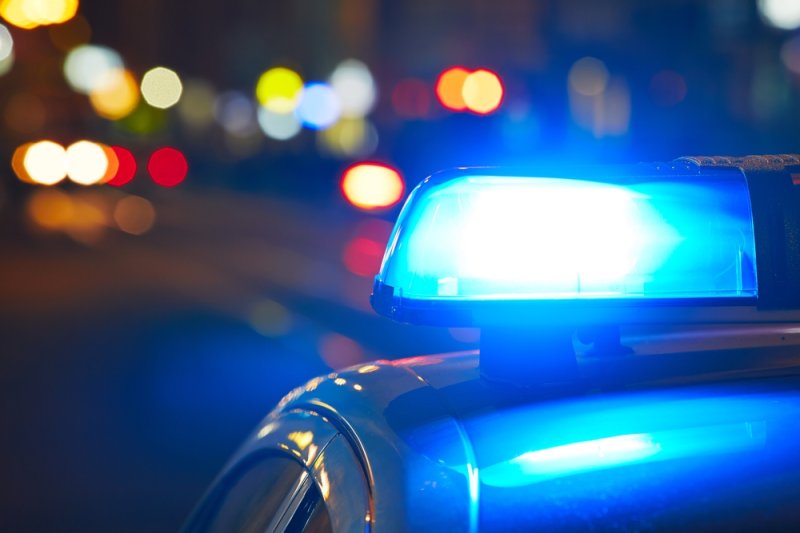 A police car with lights flashing at night. Photo by Jaromir Chalabala/Shutterstock