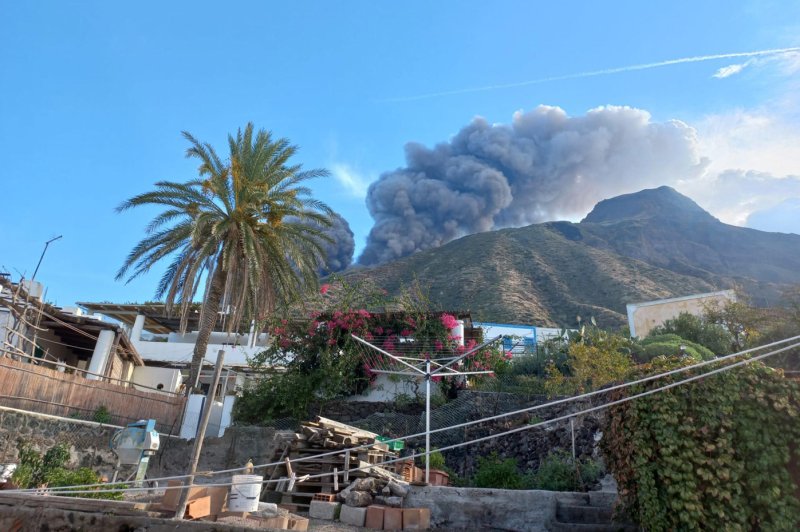 Thick smoke is visible from the hamlet of Ginostra as the Stromboli volcano erupts with lava flow oozing down the Sciara del Fuoco to the coastline. Photo by Francesco Nuccio/EPA-EFE