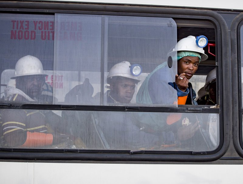 Miners who were trapped underground are transported to a safe holding area after being rescued at the Sibanye Stillwater's Beatrix mine in Welkom, South Africa, on February 2, 2018. File Photo by STR/EPA-EFE