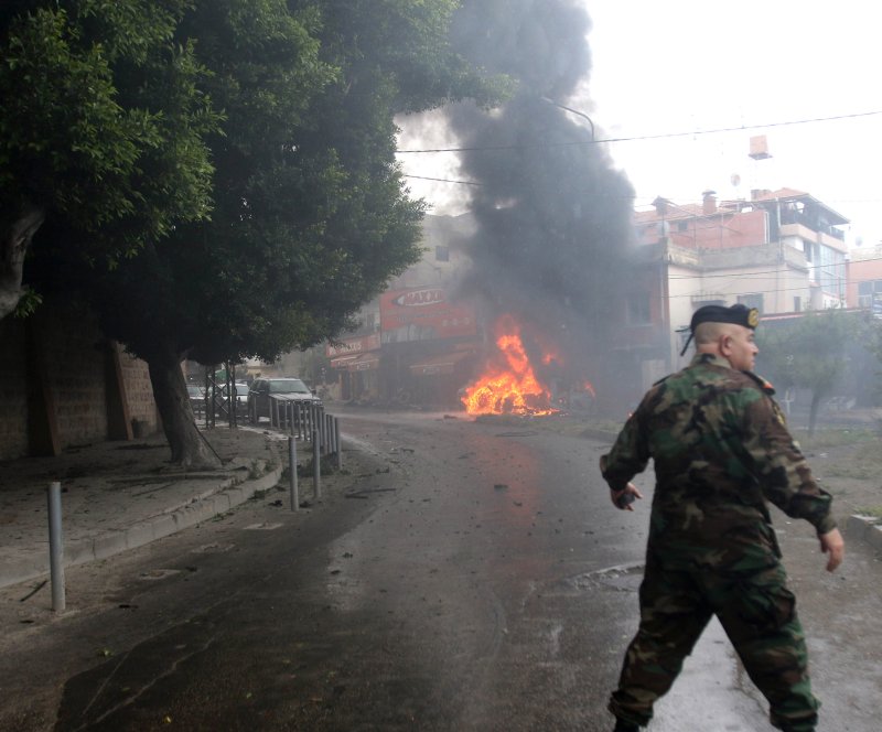 A Lebanese army soldier stands near a burning car following an explosion in southern port city of Sidon, Lebanon, last year. Fathi Zeidan, a Palestinian security official in the Fatah movement, was killed by an explosive device planted inside his car that exploded near Ain al-Hilweh Palestinian refugee camp. Photo by EPA