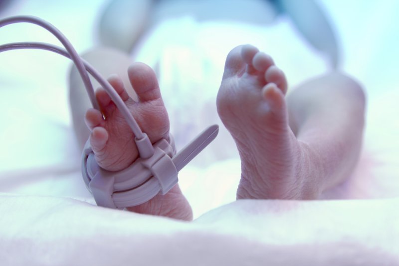 The feet of a newborn baby under an ultraviolet lamp. Photo by Praisaeng/Shutterstock