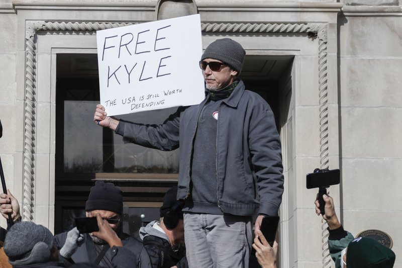 Brandon Lesco stands with a sign outside the Kenosha County courthouse as the jury returns a not guilty verdict in the trial of Kyle Rittenhouse in Kenosha, Wis., on Friday. Photo by Tannen Maury/EPA-EFE