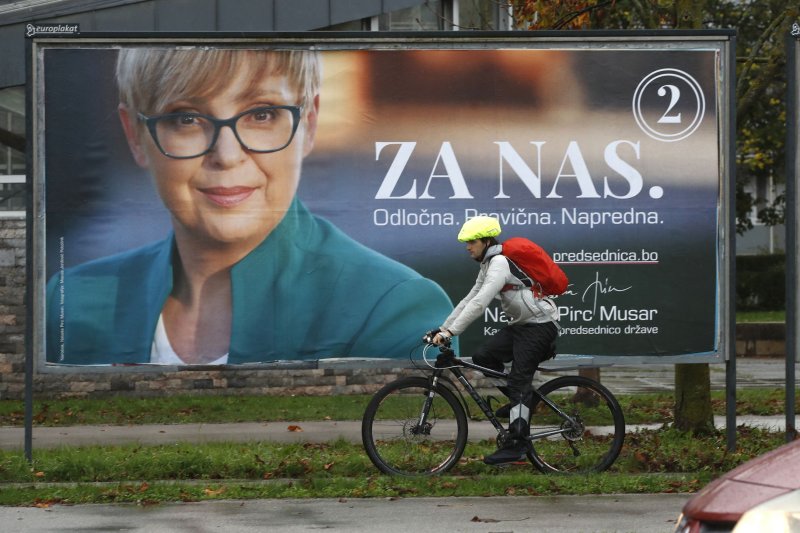 A man passes near a huge pre-election poster of presidential candidate Natasa Pirc Musar in downtown Ljubljana, Slovenia, on Thursday. Photo by Antonio Bat/EPA-EFE