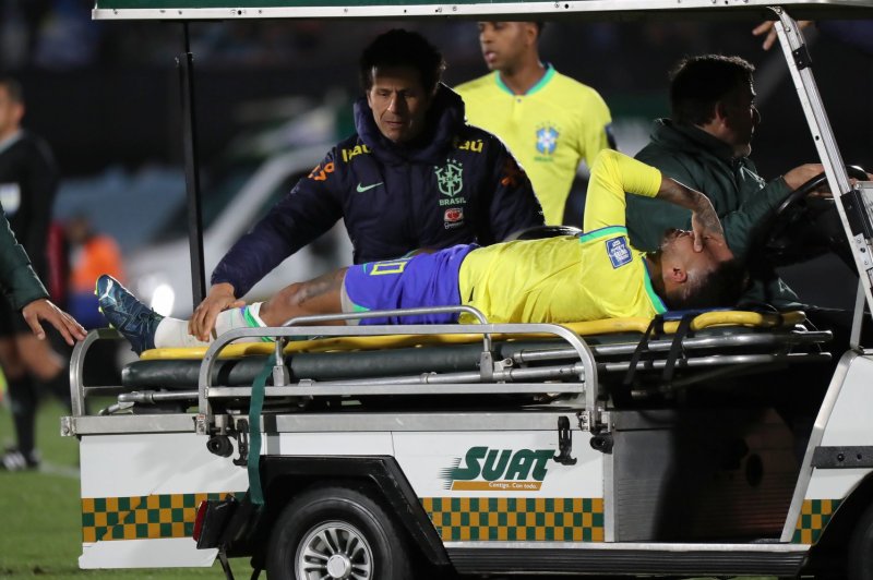 Brazil striker Neymar reacts while being taken off the field on a cart because of a knee injury he sustained in a 2-0 loss to Uruguay on Tuesday in Montevideo, Uruguay. Photo by Raul Martinez/EPA-EFE