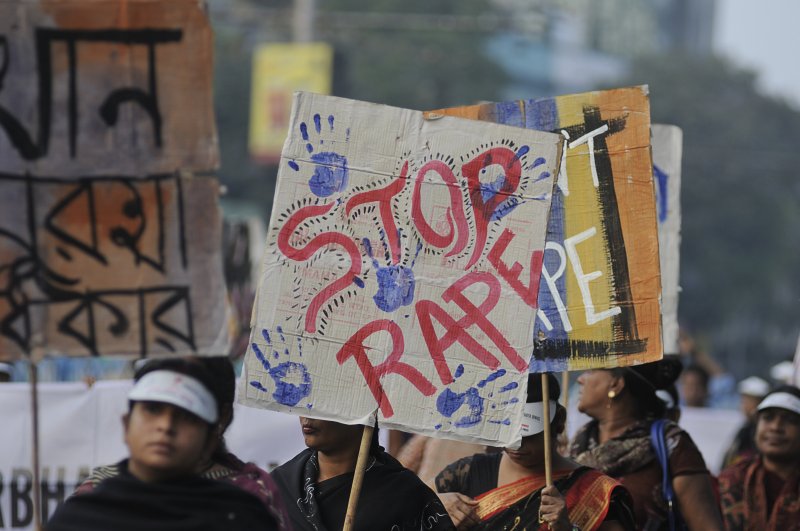 People marching on the streets with "stop rape" signs during a rally to remember a gang rape victim from New Delhi. Photo by arindambanerjee/Shutterstock