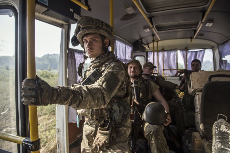 Ukrainian servicemen ride a bus to their positions near the city of Severodonetsk of the Luhansk area of Ukraine on June 19. Ukrainian forces on Friday started retreating from the city. Photo by Oleksandr Raushniak/EPA-EFE