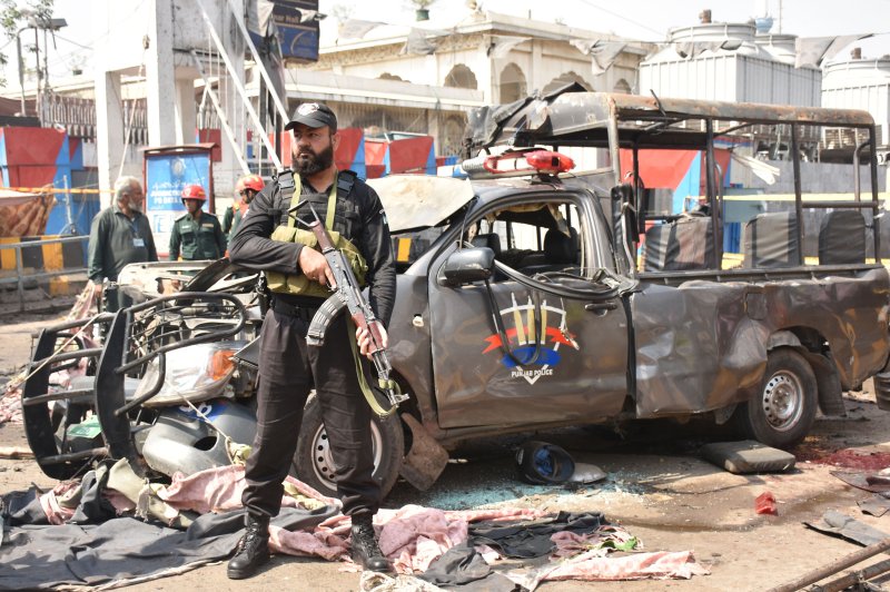 Pakistani security officials inspect the scene of a suicide bomb attack that targeted a police vehicle outside the Sufi Muslim Data Darbar shrine in Lahore, Pakistan. Photo by EPA-EFE