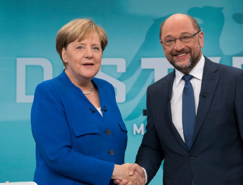 German Chancellor Angela Merkel (L) and and her opponent Martin Schulz shake hands before their televised debate Sunday in Berlin. They both don't want Turkey joining the European Union, which angered Ankara. Photo by pool/German TV broadcaster WDR/EPA