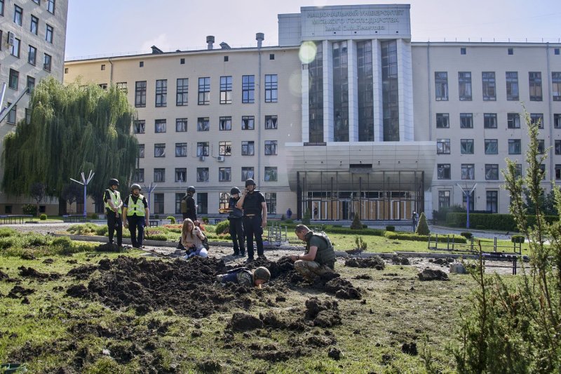 Policemen inspect the scene after shelling hit the premises of the National University of Urban Economy in Kharkiv, northeastern Ukraine, on Saturday. Kharkiv and surrounding areas have been the target of heavy shelling since February when Russian troops entered Ukraine. Photo by Sergey Kozlov/EPA-EFE
