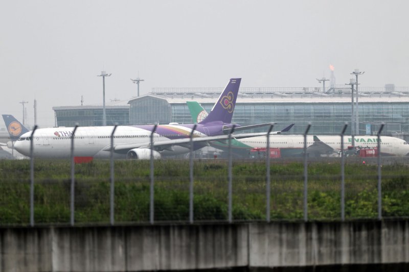 Thai Airways (L) and Eva Airways aircraft are seen on a taxiway at Haneda airport in Tokyo on Saturday after they came into contact with each other. No injuries were reported. Photo by Jiji Press/EPA-EFE