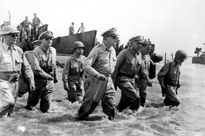 General Douglas MacArthur and staff, accompanied by Philippine president Sergio Osmena (right), land at Palo Beach, Leyte, on Oct. 21, 1944. File Photo by US Army/UPI