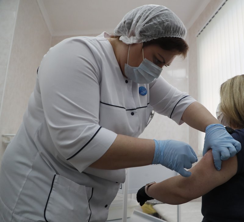 A Russian medic inoculates a woman with Russia's vaccine against COVID-19 disease at a clinic in Moscow on Saturday. Photo by Maxim Shipenkov/EPA-EFE