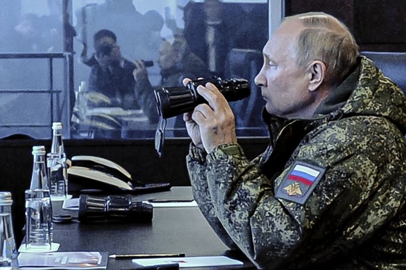 Russian President Vladimir Putin observes the Vostok 2022 strategic command post exercises, which involve the Eastern Military District troops, at the Sergeevsky training ground, in Primorsky krai region, Russia, Tuesday. Over 50,000 people, more than 5,000 military vehicles, including 140 aircraft, 60 vessels are involved in the drills. Pool Photo by Mikhael Klimentyev/Sputnik/Kremlin/EPA-EFE