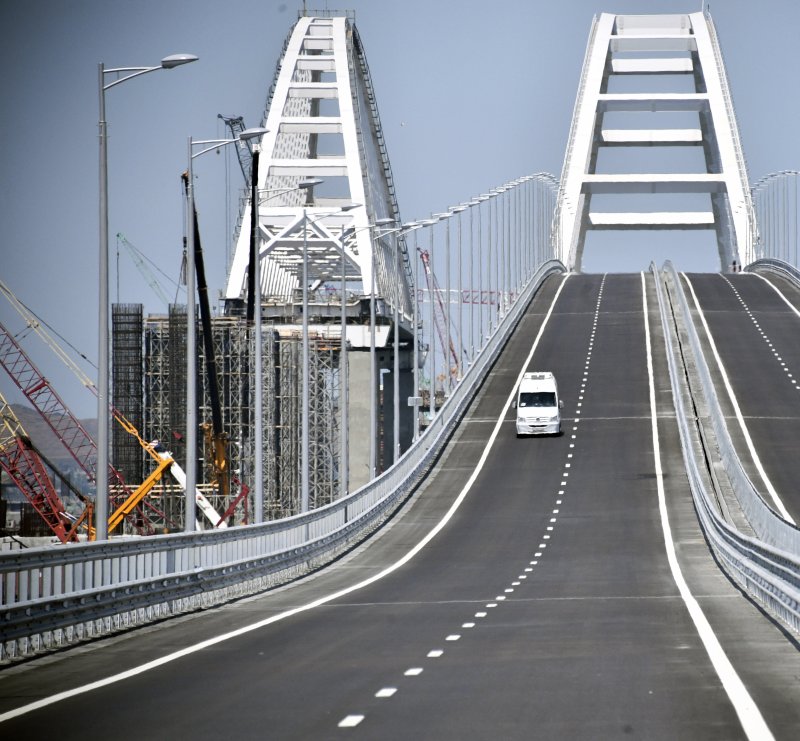 A car drives on the Krymsky Bridge over the Kerch Strait on May 15, 2018, prior to its opening ceremony. File Phot Alexander Nemenov/EPA-EFE