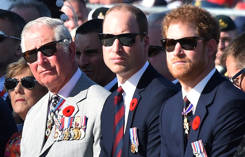 Meghan Markle has asked Prince Charles, seen here with Prince William and Prince Harry at the Canadian National Vimy Memorial on April 9, 2017, to walk her down the aisle at the royal wedding. File Photo by Philippe Huguen/EPA