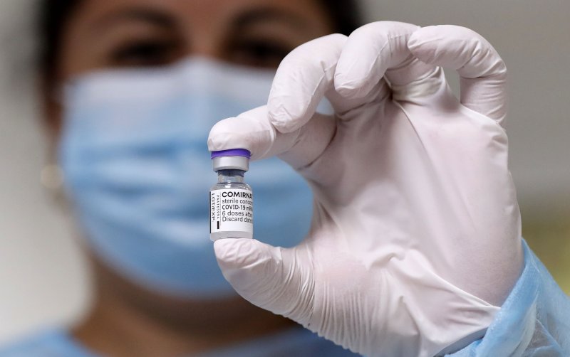 A Romanian nurse displays a vial of the Comirnaty (Pfizer) vaccine against COVID-19 before a patient gets his booster injection at hospital in Bucharest, Romania. File Photo by Robert Ghement/EPA-EFE
