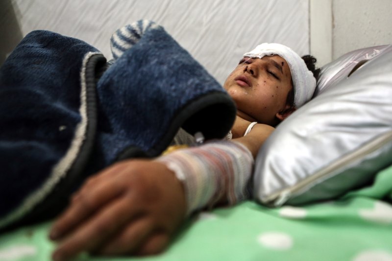 Gina Diab, 6, receives treatment in the ICU of a medical office in the rebel-held city of Douma, Syria, on November 22, 2016. She was injured on November 20 after a bombing on Douma. Her two sisters were killed in the same attack. UNICEF said more Syrian children were killed in 2016 than any other year of the country's civil war. Photo by Mohammed Badra/EPA