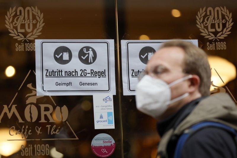 An information sign with letters "Access according to 2G rule, vaccinated recovered" is placed on a window at a cafe in the old town of Heidelberg, Germany, on Thursday. Due to an increasing number of cases of the pandemic COVID-19 disease caused by the coronavirus, new nationwide restrictions have been announced to counter a surge in infections. Photo by Ronald Wittek/EPA-EFE