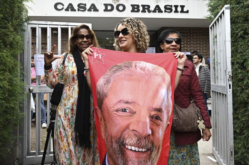 Daily News A Brazilian voter holds a banner picturing presidential candidate Lula da Silva after casting her ballot as she leaves a polling station during the second round of the Brazilian presidential election at Casa do Brasil, in Madrid, Spain, on Sunday. Photo by Fernando Villar/EPA-EFE